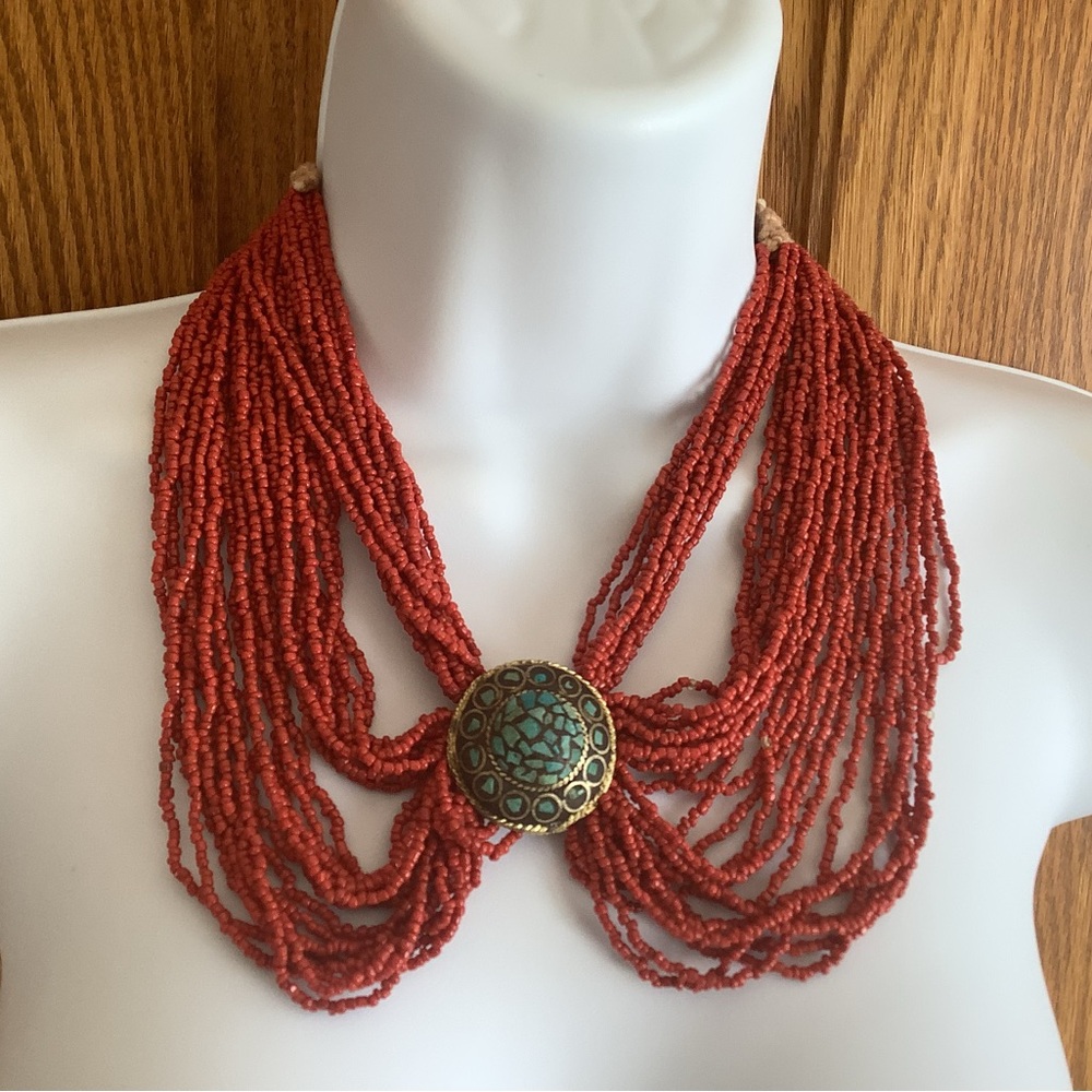 Coral colored beaded necklace, with Indian coin clasp.